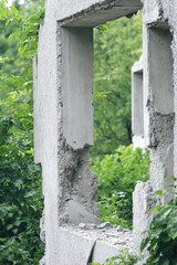 A ruined suburban building. Concrete collapsing slabs of walls. Abandoned demolition site