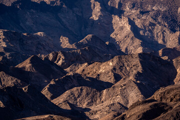 The vast golden dunes of Namibia stretch endlessly under the clear blue sky