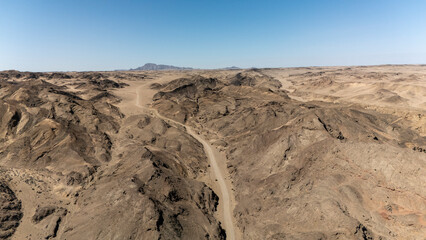 Namibian desert roads stretch endlessly as a 4x4 tackles the wild terrain