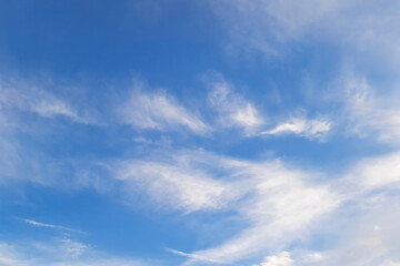 Naklejka premium Serene blue sky with wispy white clouds on a clear day, Heavenly sky peaceful nature scene or background