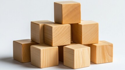 Obraz premium Stacked wooden blocks arranged in a creative formation on a clean background, ideal for educational use