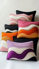 Brightly colored cushions in varied shapes and textures are artfully arranged, showcasing a delightful blend of orange, pink, purple, and neutral tones