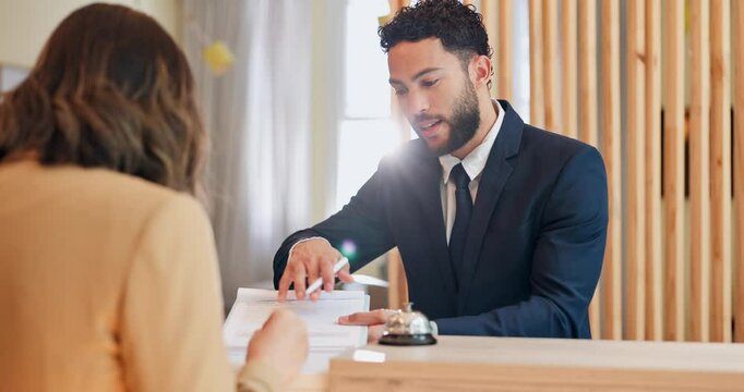 Woman, man and concierge with documents at hotel, welcome or business trip with smile for check in. People, hospitality and happy at help desk for booking, travel and services with paperwork in lobby