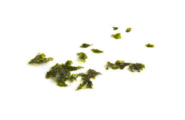 crumbs from nori chips on white background © Kirill