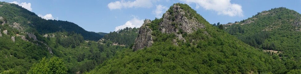 Rhodopes, are a mountain range in Southeastern Europe. Bulgaria. Panorama. The forest area covers the mountains.