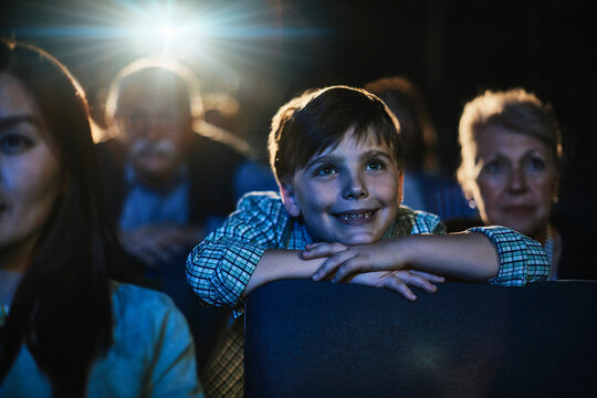 Happy boy watching movie in cinema