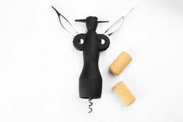Wing corkscrew and corks on white background, top view