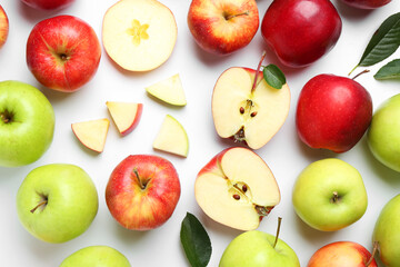 Flat lay composition with whole and cut apples on white background