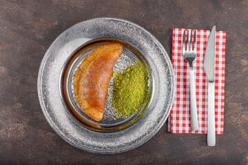 Traditional Turkish dessert called Arab Kadaif or tas kadayif. Turkish Dessert Tas Kadayif with walnuts.