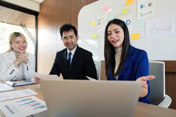 Diverse business team discussing financial strategies and insights in a modern office setting.