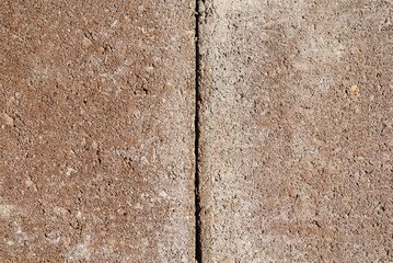 Two red brown paving stone tiles close-up abstract textured background