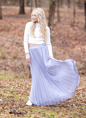 Pretty Blonde Girl in long flowy dress posing
