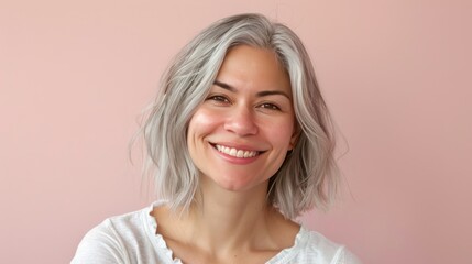 A headshot of a person with platinum blonde hair, wearing a hoodie, against a soft bokeh background.