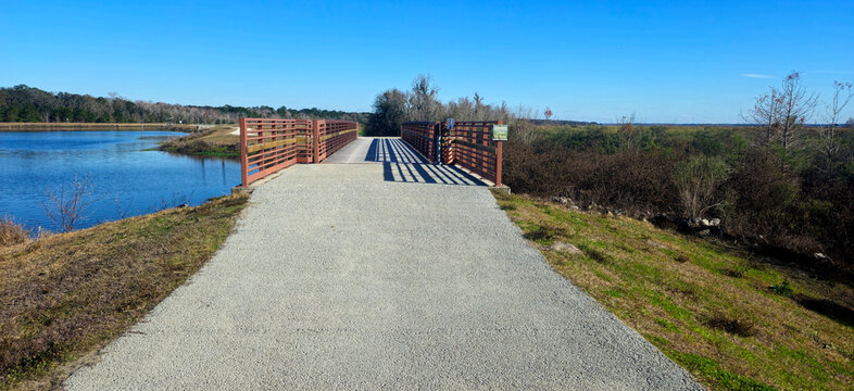Looking at a bridge going over the water at a park