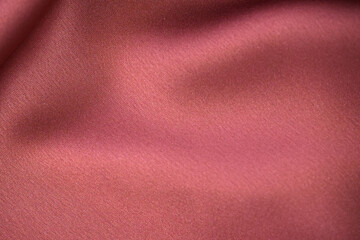 Fototapeta premium Luxury red satin smooth fabric background. Abstract background luxury red cloth or liquid wave or wavy folds of silk satin background. Red silky fabric.