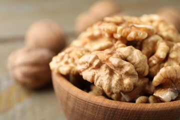 Peeled walnuts in bowl on table, closeup