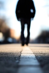 Fototapeta premium Mysterious silhouette of a person walking alone on an empty street : Generative AI