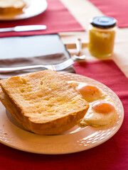 Fresh homemade bread with eggs on white plate. Home Breakfast.