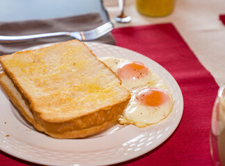 Fresh homemade bread with eggs on white plate. Home Breakfast.