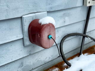 Outdoor home spigot or faucet cover for cold weather during winter season to prevent frost