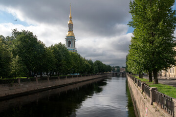 Naklejka premium View of the Kryukov Canal embankment and the bell tower of St. Nicholas Naval Cathedral on a sunny summer day, St. Petersburg, Russia