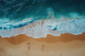 Two people walking on the beach at sunset, holding hands and gazing at the ocean.