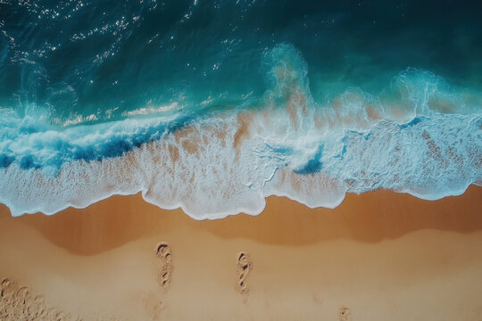 Two people walking on the beach at sunset, holding hands and gazing at the ocean.