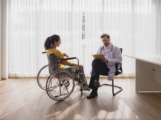 Health care latin woman sick sit wheelchair with man doctor caucasian two people check and treat patients talk help support explain medicine sick person in take care your health hospital clinic