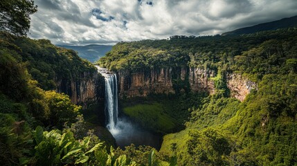 Majestic waterfall cascading into lush rainforest valley