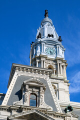 Historic clock tower stands tall against a clear blue sky