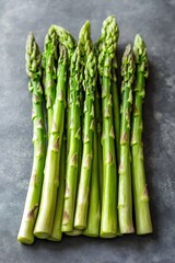 Fresh green asparagus stalks stacked neatly on a modern grey background for healthy eating : Generative AI
