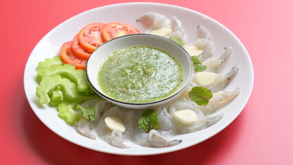 shrimp in fish sauce with Thai spicy seafood dipping sauce on white plate