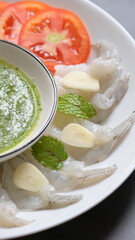 shrimp in fish sauce with Thai spicy seafood dipping sauce on white plate