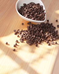 Chocolate chips on wooden board. copy space.