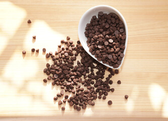 Chocolate chips on wooden board. copy space.