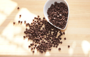 Chocolate chips on wooden board. copy space.