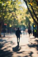 Obraz premium Silhouette of a person walking along a tree-lined path during golden hour in soft focus : Generative AI