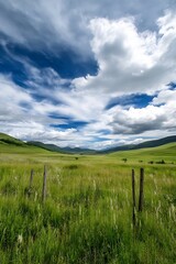 Obraz premium Expansive Green Field with Rolling Hills Under a Dramatic Sky for Nature Lovers and Landscape Photography : Generative AI