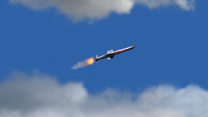 Missile flying in sky. Missile launch and attack. Cruise missile fly in clouds.