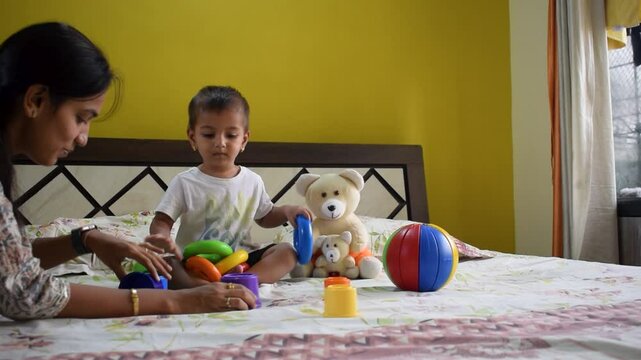 Baby boy toddler kid child son and mother woman playing with toys Colors happy love care learning development growth education home skills sensory organs. School, nursery, playgroup teacher