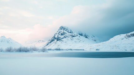 Obraz premium Serene Winter Landscape with Snow-Capped Mountains and Calm Lake Reflections in a Tranquil Setting at Dusk
