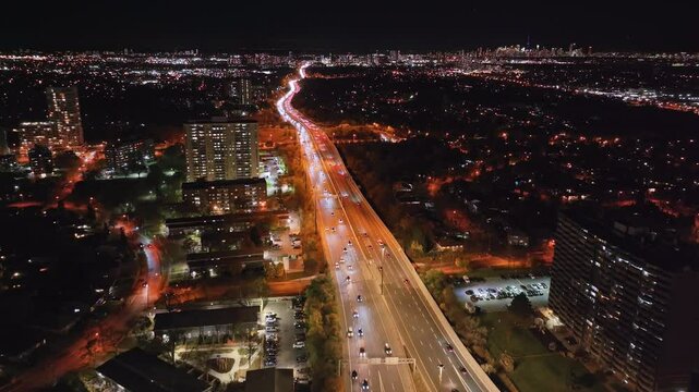 Nighttime aerial view of Highway 401 and 404 in Ontario, Canada with city lights