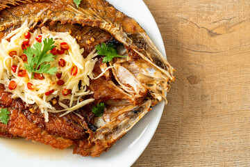 Fried Sea Bass Fish with Fish Sauce and Spicy Salad
