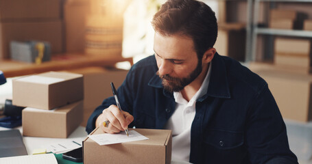 Man, writing and note on box for distribution process of online orders, invoice and shipping information. Person, paper and ecommerce label with package delivery, payment sticker and small business