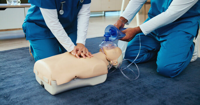 Mask, medical or nurses learning cpr on mannequin for first aid, help cardiac arrest or safety protocol. Healthcare class, hands or people with respiratory tool in paramedic course or nursing school
