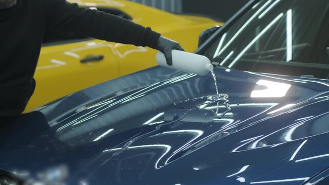 Water-repellent effect demonstration on a car hood after hydrophobic coating application