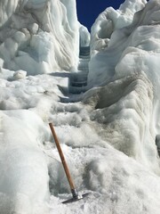 Ice axe on glacial ice stairs