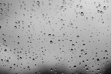 black and white moody raindrops on a window glass