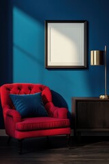 Cozy interior featuring a vibrant red armchair, elegant lamp, and blank wall art mockup against a bold blue backdrop. Perfect for decor inspiration. Template.