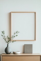 Modern minimalist wall art mockup featuring an empty frame, decorative vase, and stylish accessories, perfect for interior design inspiration. Template ready for use.
